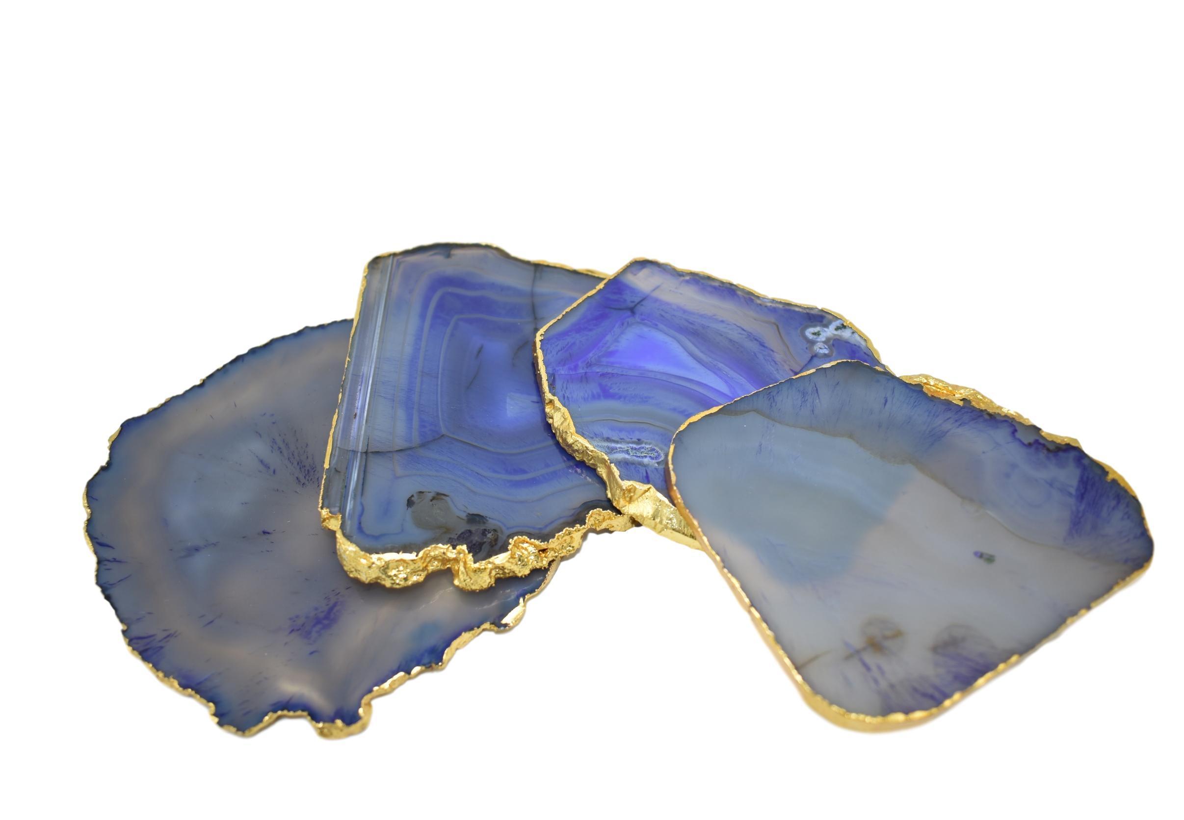 Set of four gnarled agate coasters with gold trim, showcasing unique natural patterns and vibrant colors.