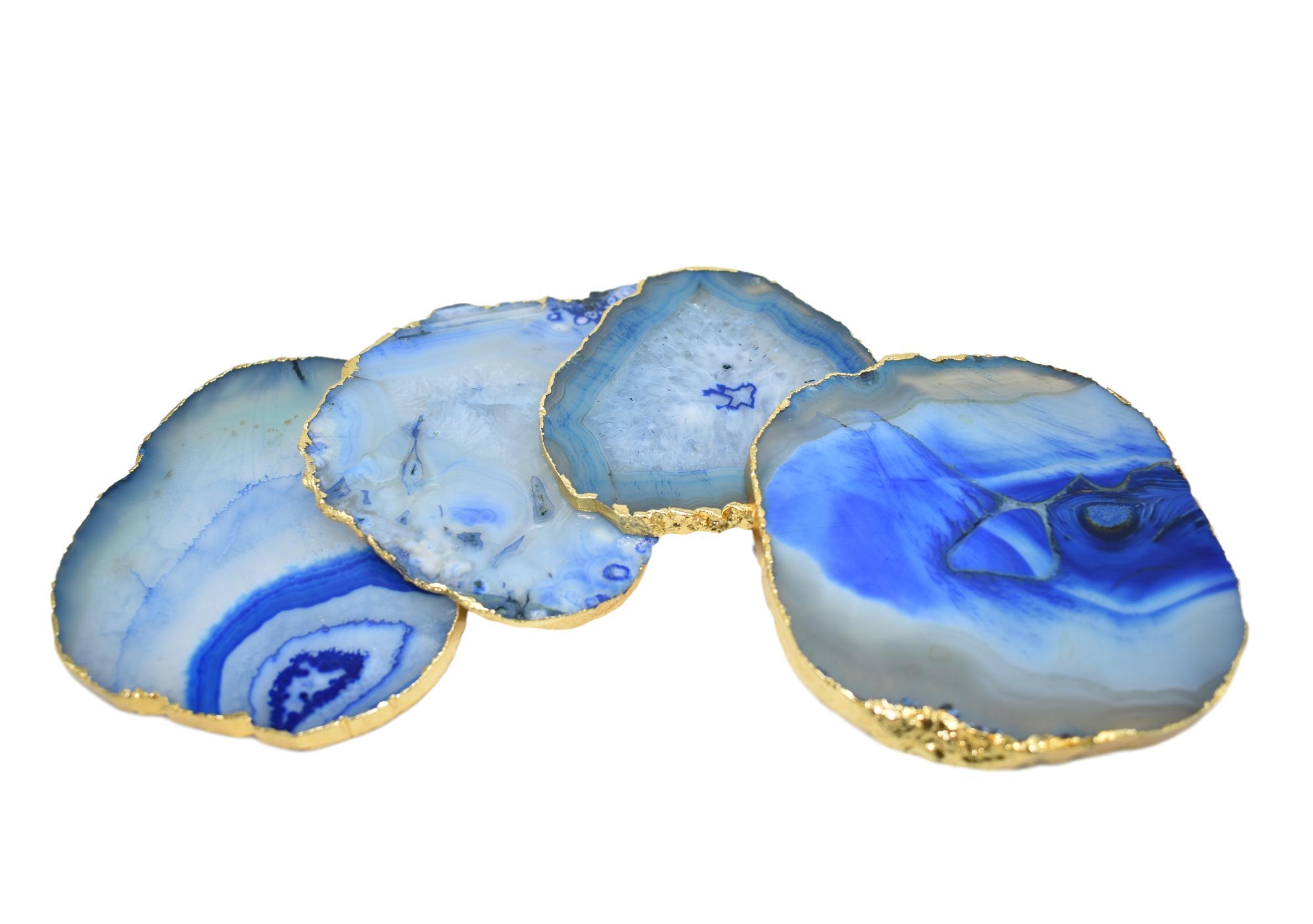 Set of four gnarled agate coasters with gold trim, showcasing unique natural patterns and vibrant colors.