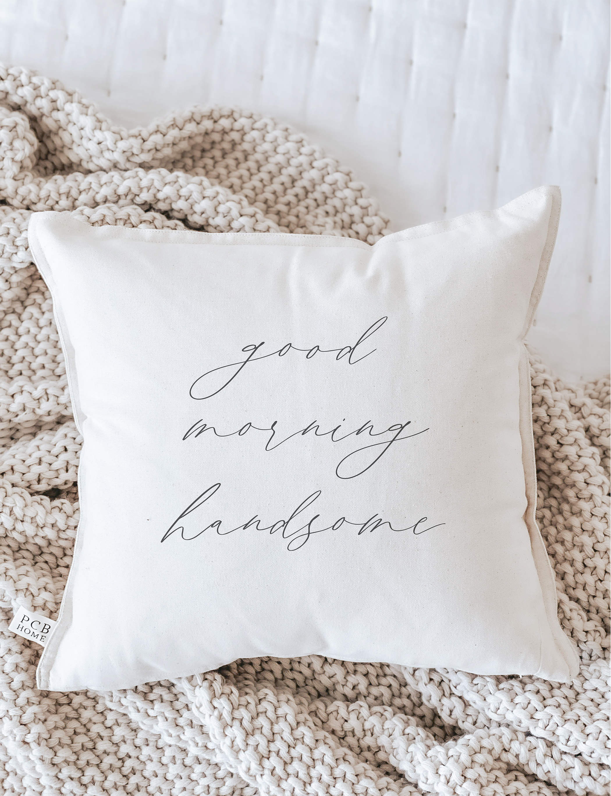 Good Morning Handsome Pillow featuring unique calligraphy design on soft cotton fabric, available in white and natural colors.