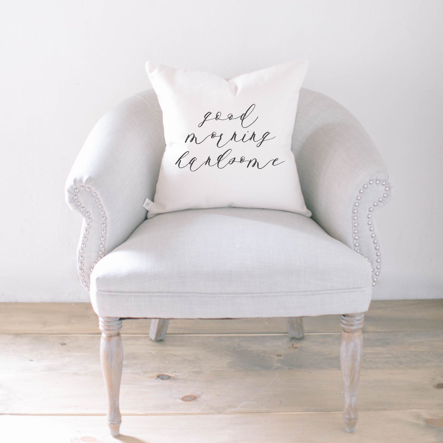 Good Morning Handsome Pillow featuring unique calligraphy design on soft cotton fabric, available in white and natural colors.