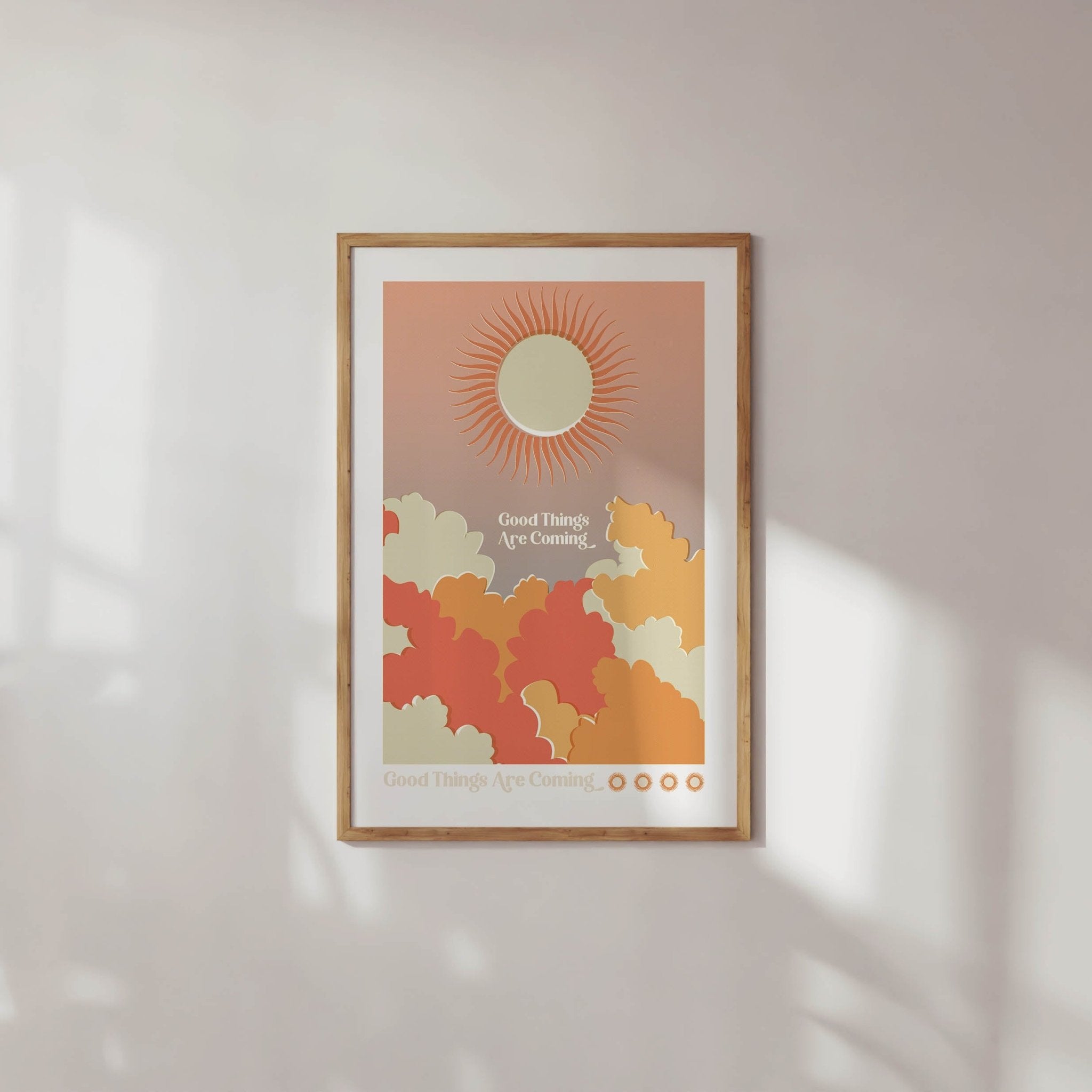 Good Things Are Coming art print featuring retro word art with sun and cloud imagery in warm colors.