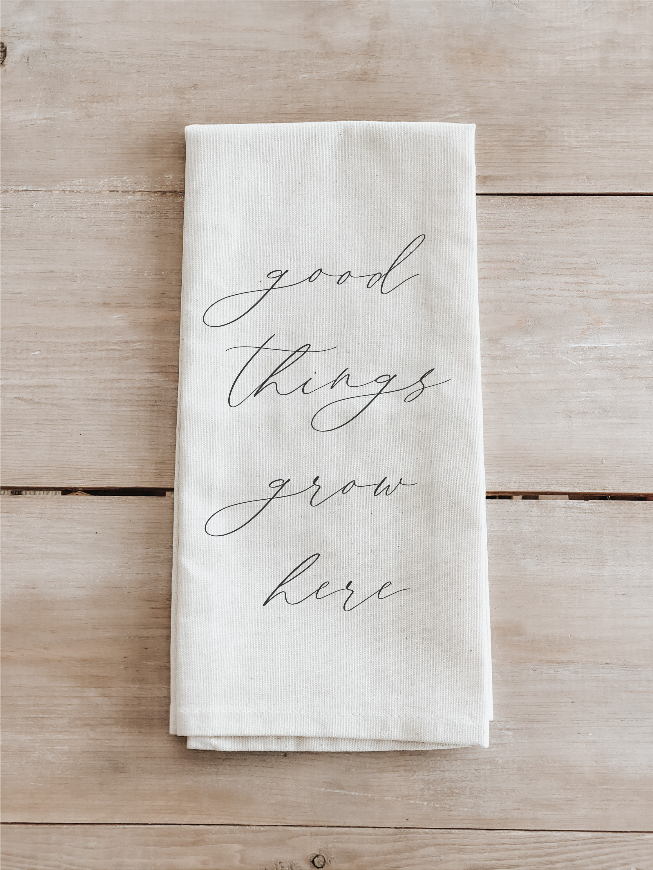 Good Things Grow Here Tea Towel made from organic cotton, featuring an inspiring design in white and natural colors.