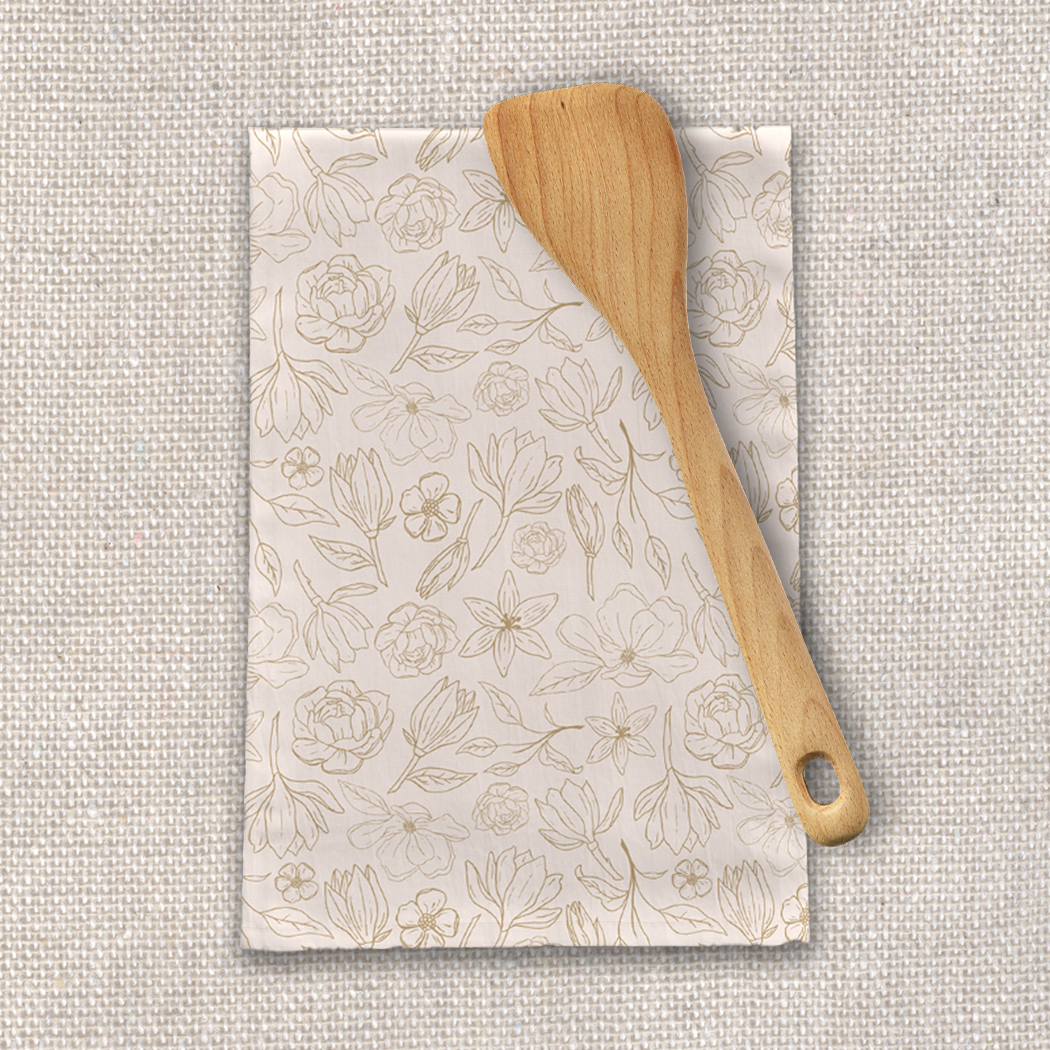 Gold Magnolia Tea Towel featuring a beautiful floral design on soft cotton twill fabric, perfect for kitchen use.