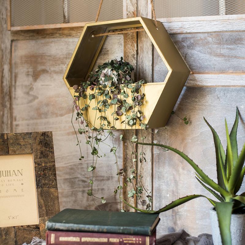 Gold Metal Hexagon Hanging Planter showcasing its modern design and durable construction, perfect for indoor and outdoor decor.