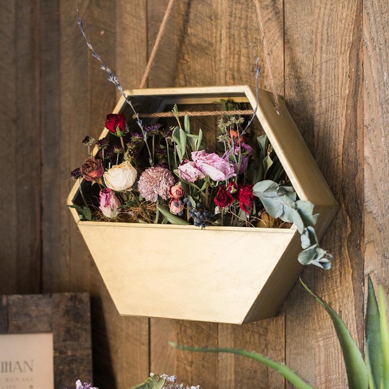 Gold Metal Hexagon Hanging Planter showcasing its modern design and durable construction, perfect for indoor and outdoor decor.