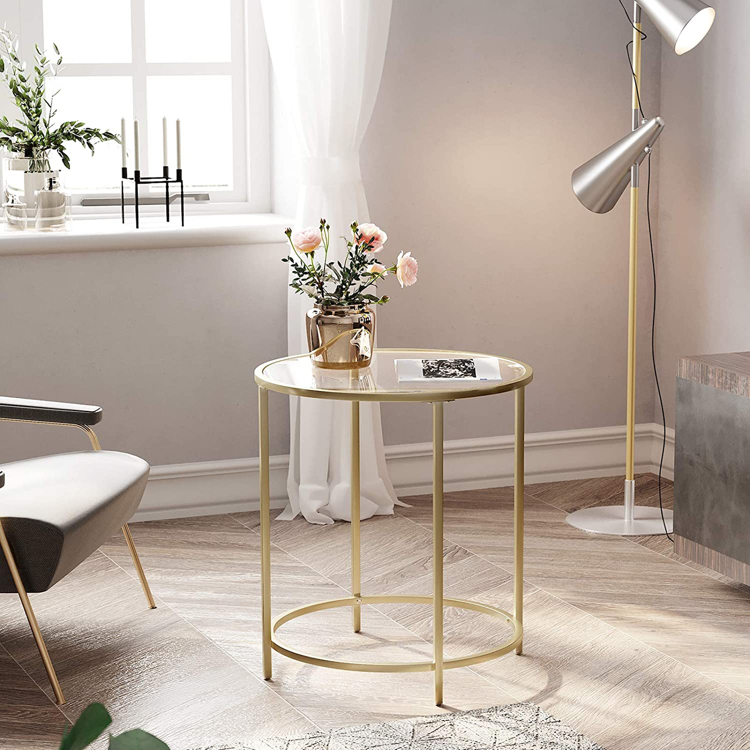 Gold Round Side Table featuring a golden metal frame and a clear tempered glass top, showcasing a minimalist design suitable for modern decor.