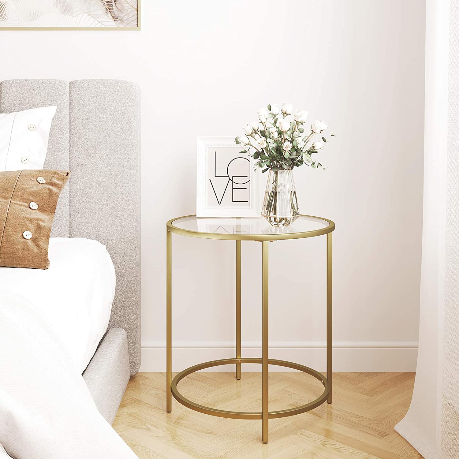 Gold Round Side Table featuring a golden metal frame and a clear tempered glass top, showcasing a minimalist design suitable for modern decor.