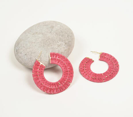 Gold-toned iron huggie earrings featuring a vibrant hot pink design, handcrafted by artisans.