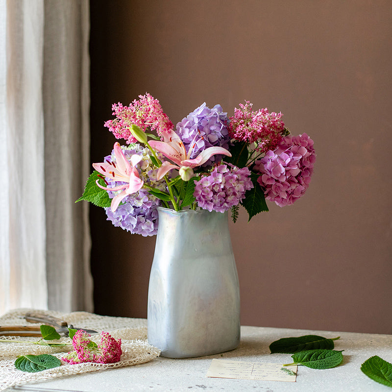 A beautifully crafted Gradient Color Art Glass Vase featuring a unique blend of pink and cream colors, showcasing its hand-blown design.