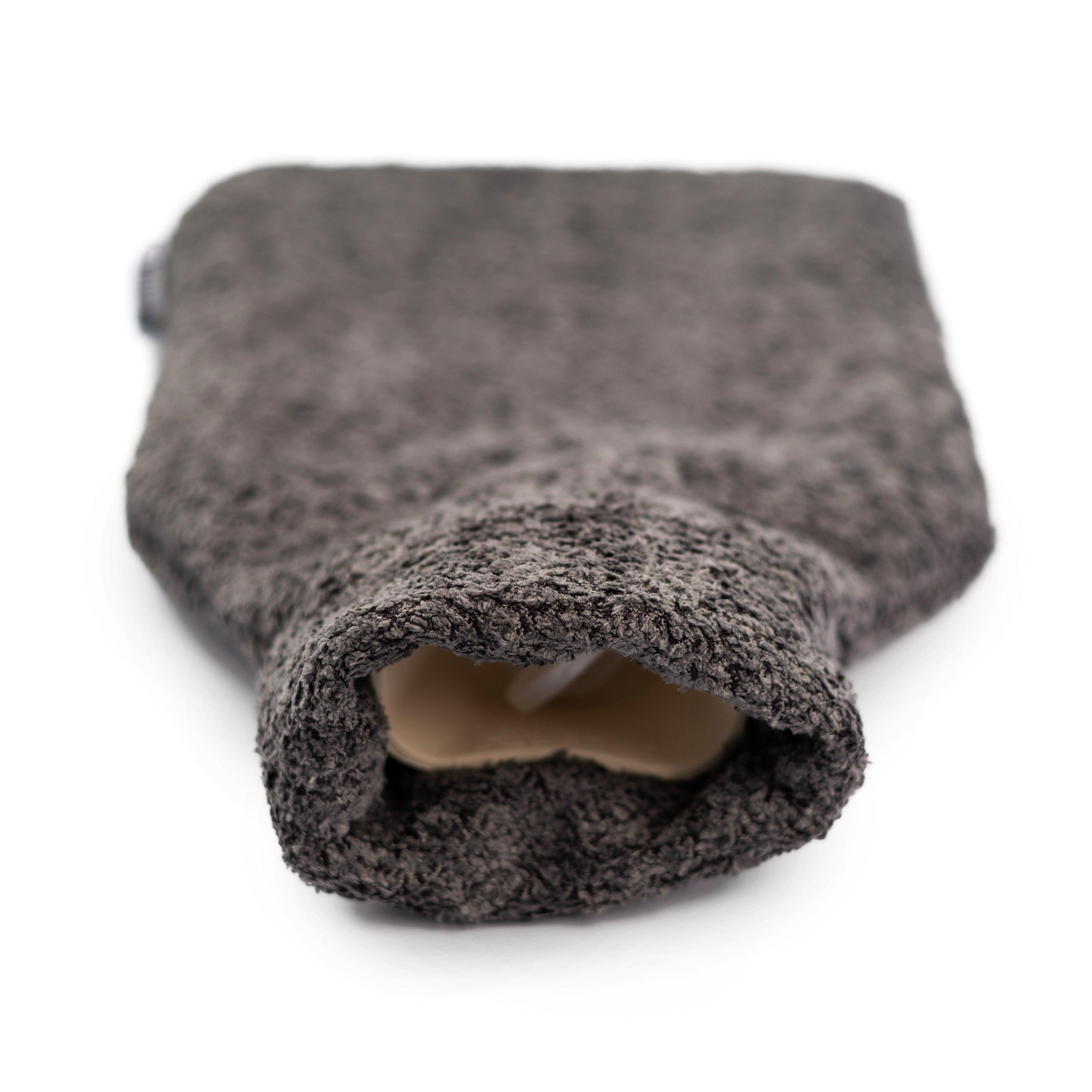 Graphite fleece hot water bottle with a stylish recycled plastic cover, showcasing its eco-friendly design and cozy texture.