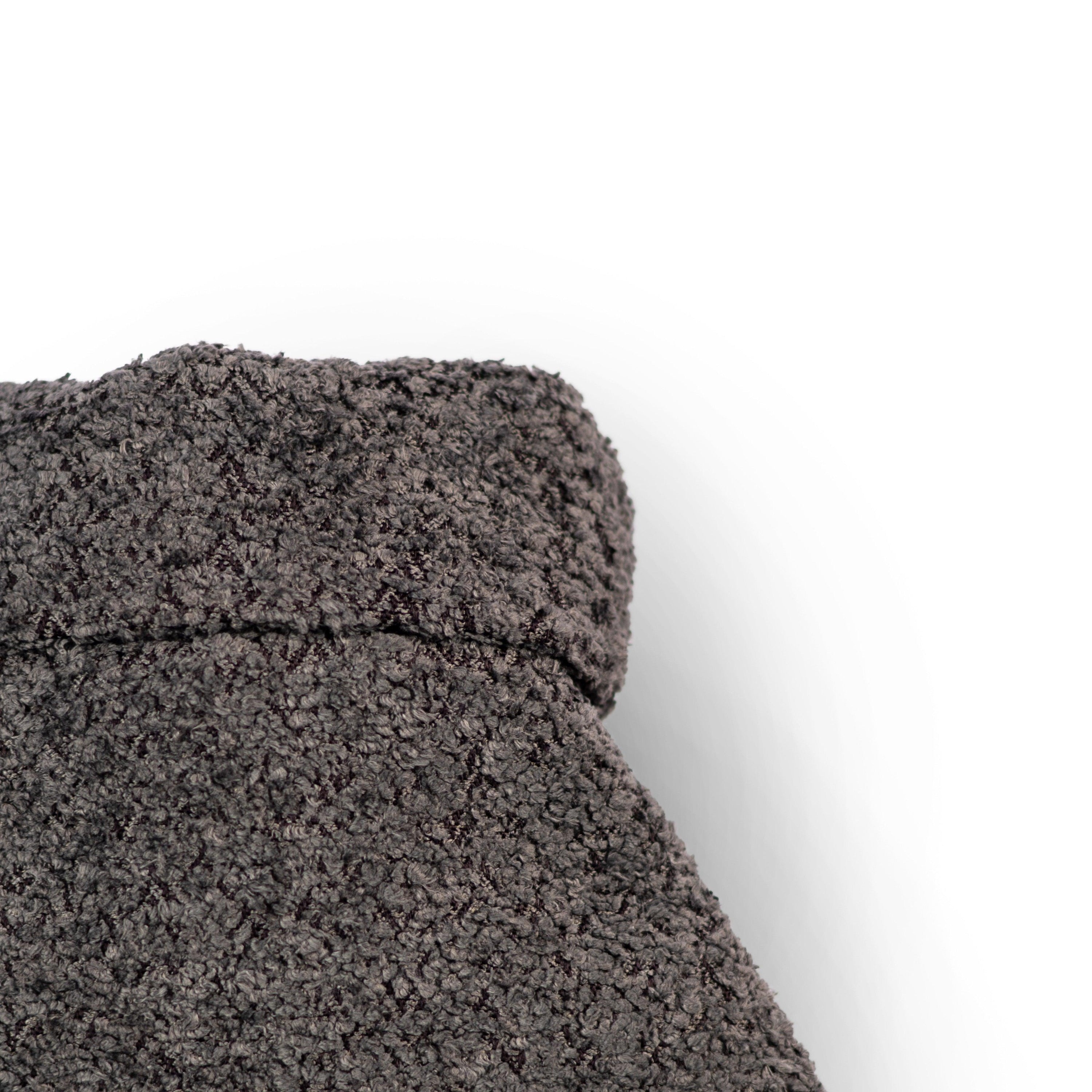 Graphite fleece hot water bottle with a stylish recycled plastic cover, showcasing its eco-friendly design and cozy texture.