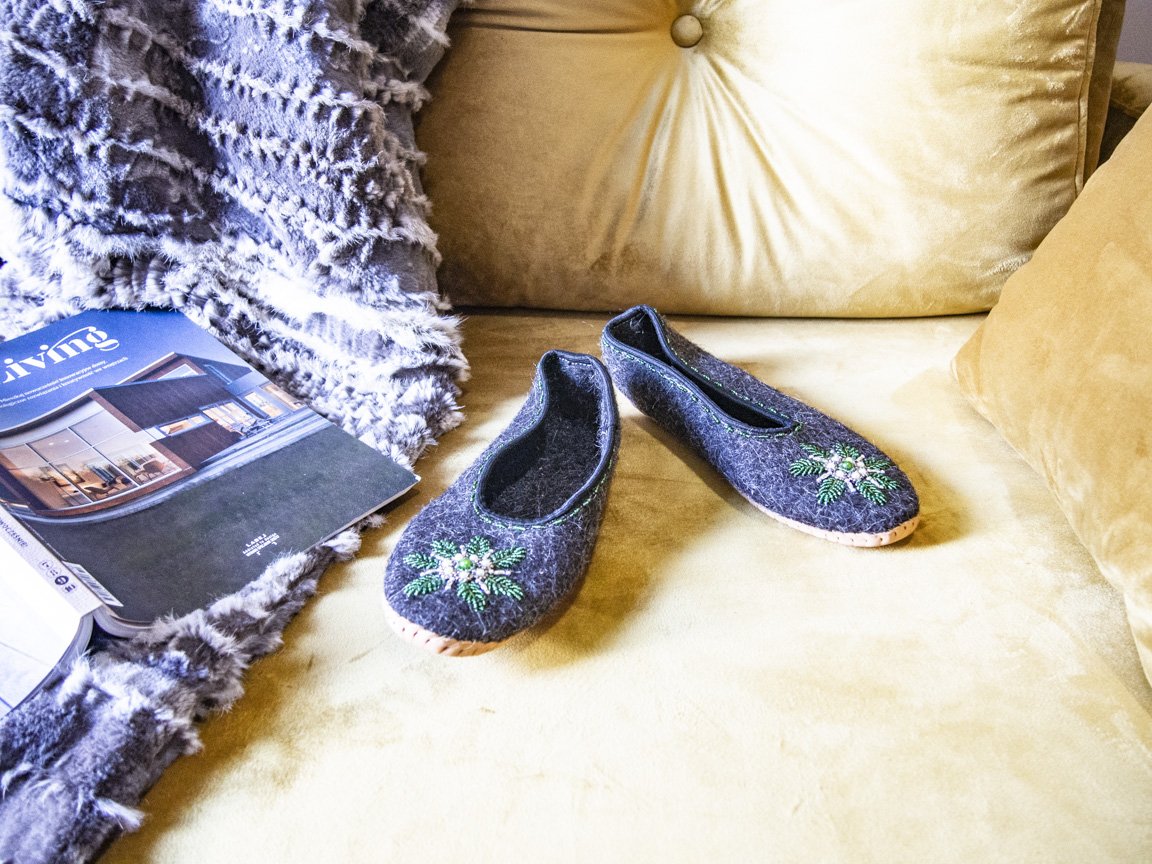 Gray felt slippers with real leather and unique handsewn beads, showcasing elegant craftsmanship.