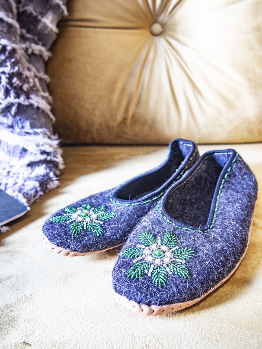 Gray felt slippers with real leather and unique handsewn beads, showcasing elegant craftsmanship.