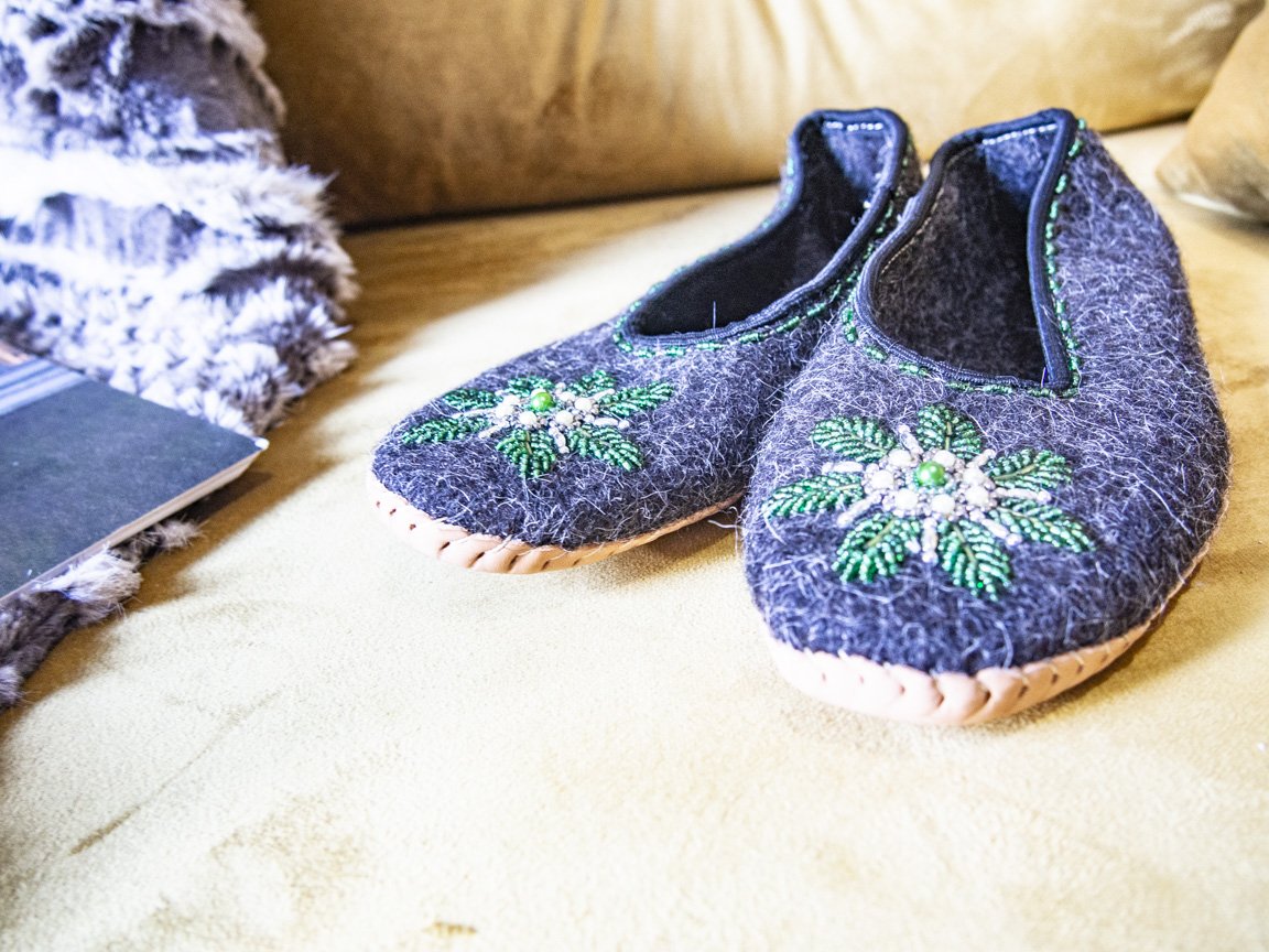 Gray felt slippers with real leather and unique handsewn beads, showcasing elegant craftsmanship.