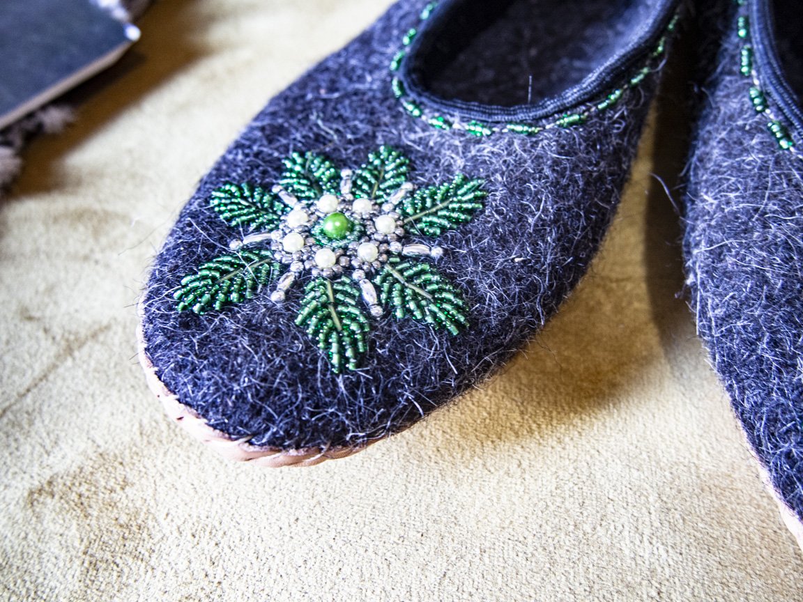 Gray felt slippers with real leather and unique handsewn beads, showcasing elegant craftsmanship.