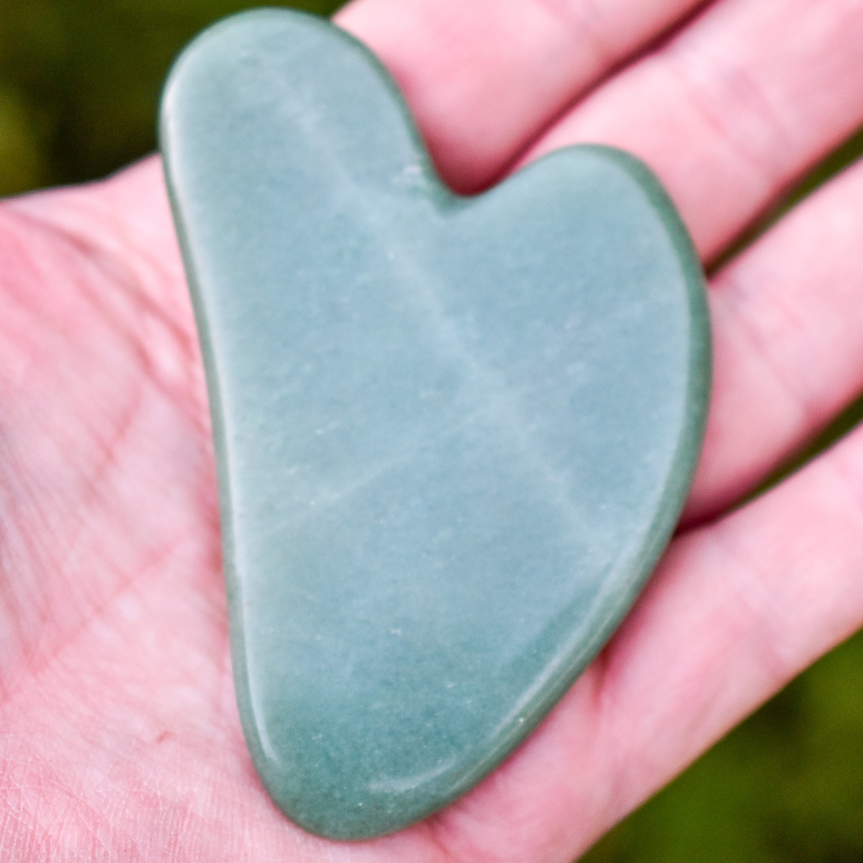 Green Aventurine Gua Sha tool designed for facial and body massage, promoting circulation and reducing wrinkles.