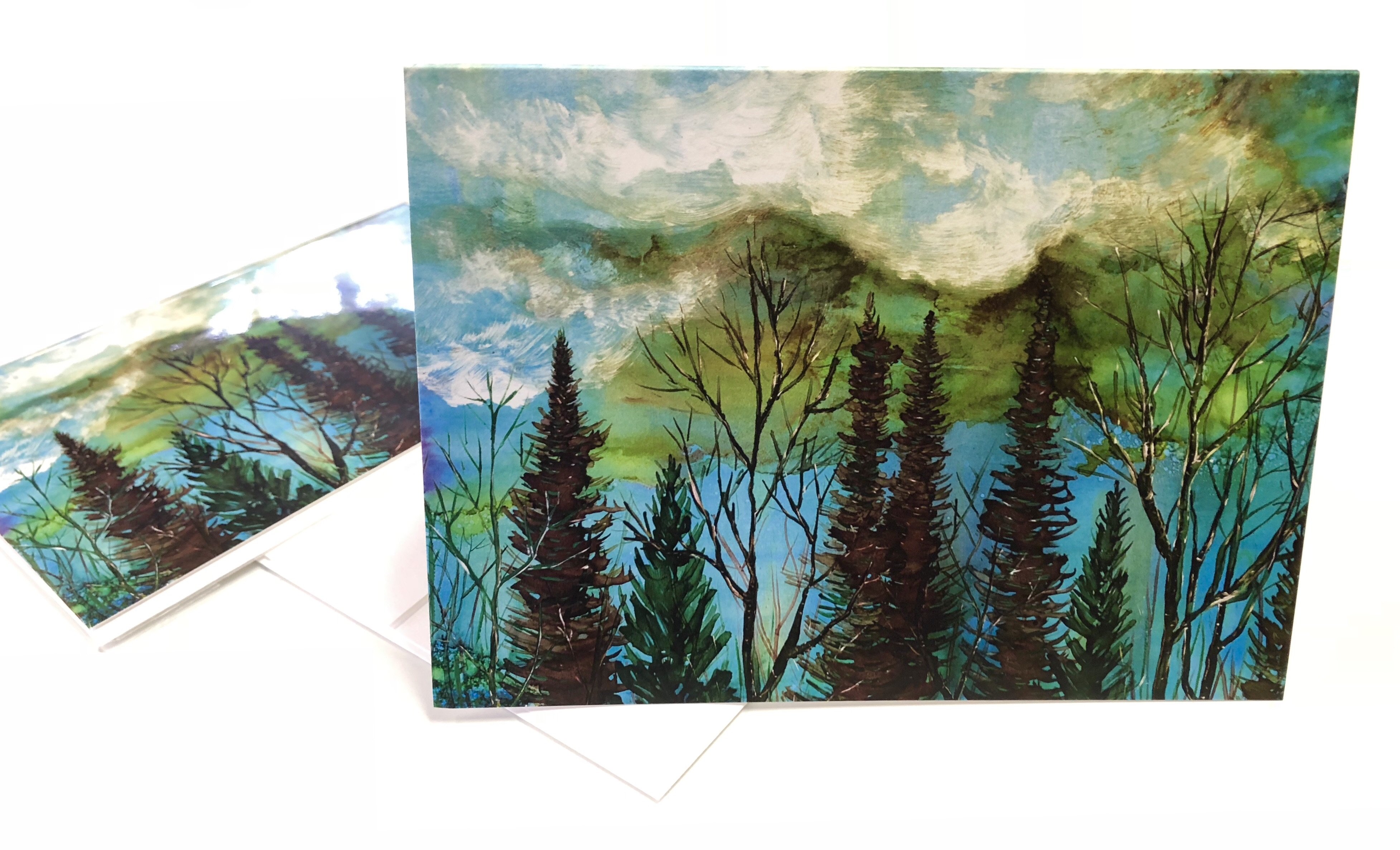 A beautiful greeting card featuring a moody landscape with a vibrant green sky and a tranquil forest below, perfect for gifting or framing.