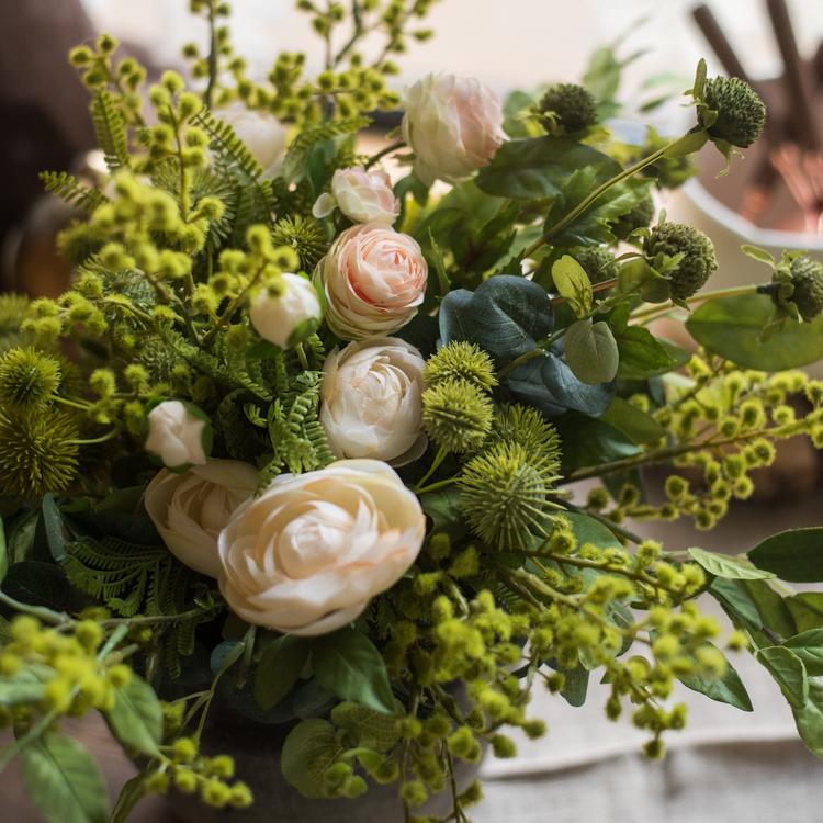 A beautiful Greenery White Rose Bouquet arranged in a handmade gray ceramic pottery, featuring lifelike white roses and lush greenery.