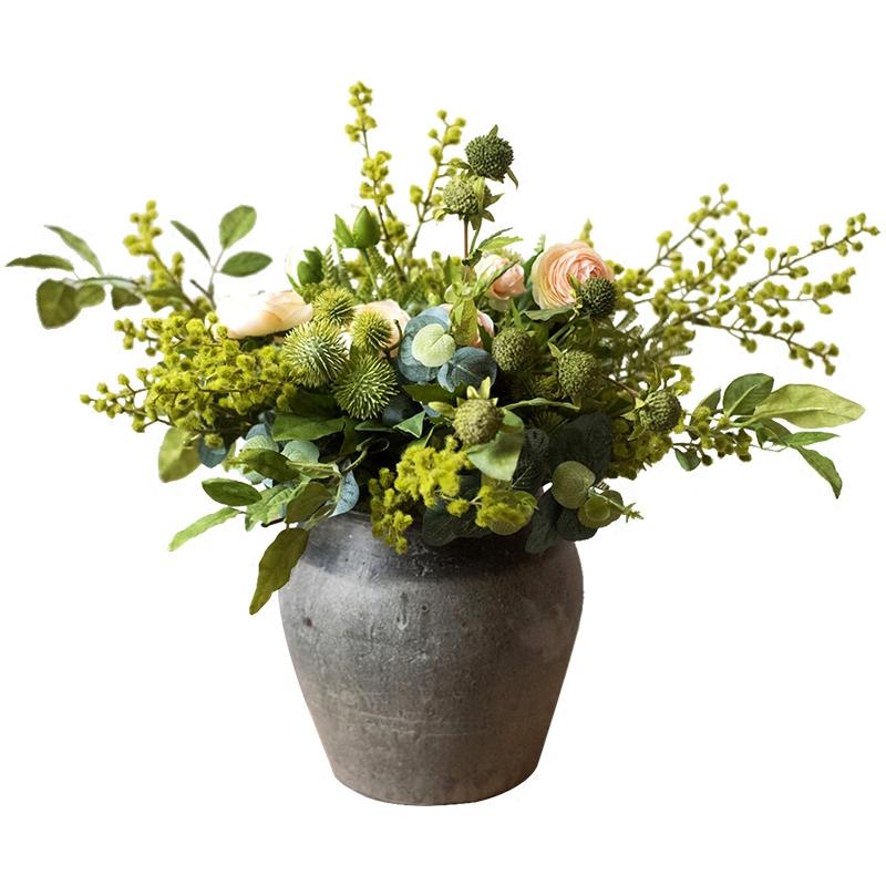 A beautiful Greenery White Rose Bouquet arranged in a handmade gray ceramic pottery, featuring lifelike white roses and lush greenery.