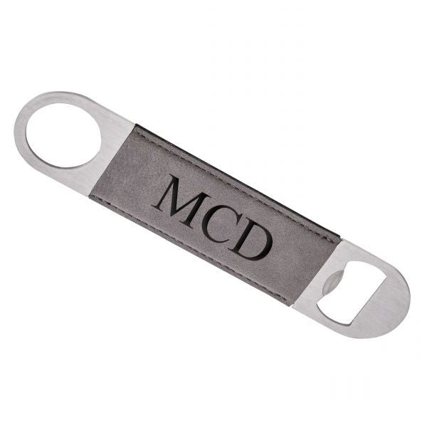 Grey leatherette and stainless steel bottle opener, measuring 7 inches by 1.5 inches, elegantly designed for easy beverage opening.