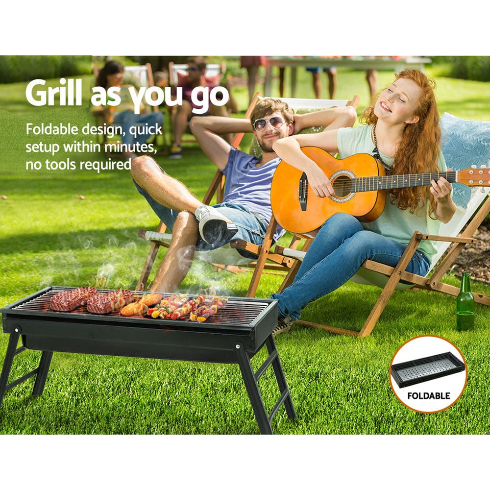 Grillz Charcoal BBQ Grill Smoker with foldable legs and stainless steel grill top, perfect for outdoor cooking.