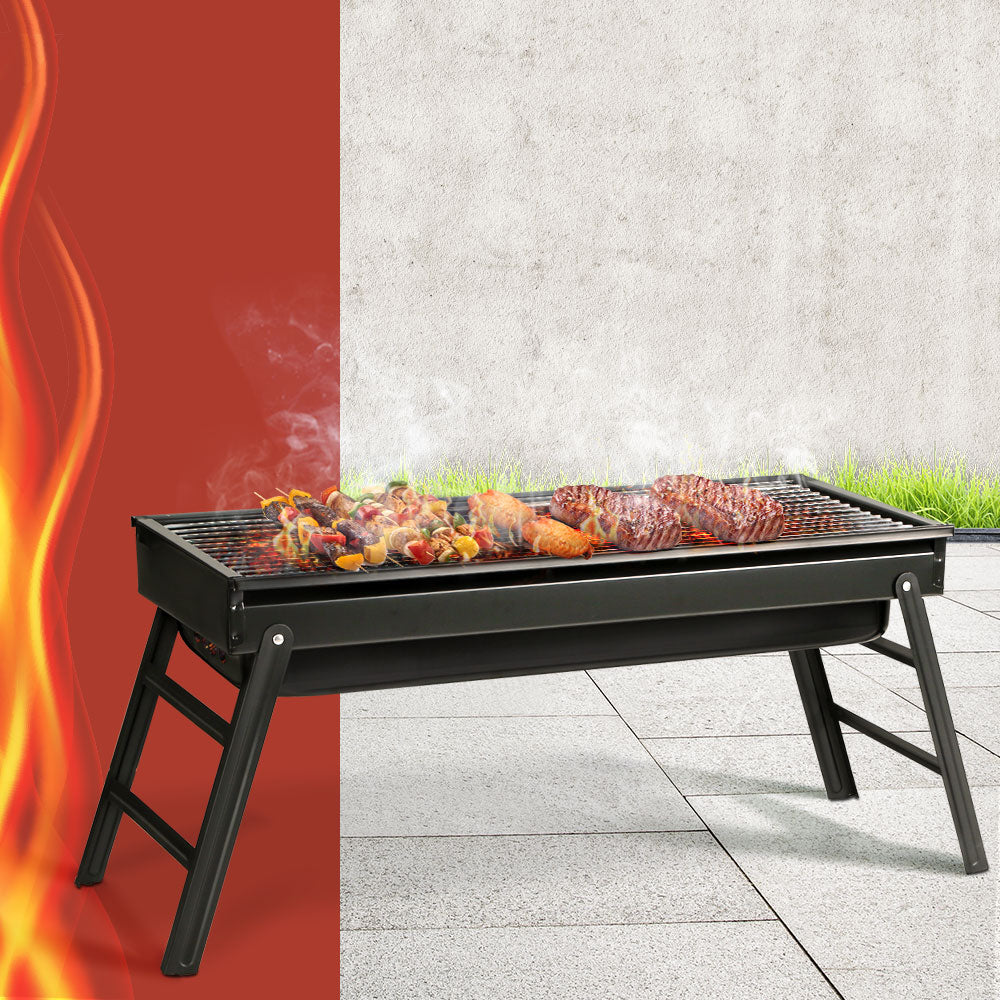 Grillz Charcoal BBQ Grill Smoker with foldable legs and stainless steel grill top, perfect for outdoor cooking.