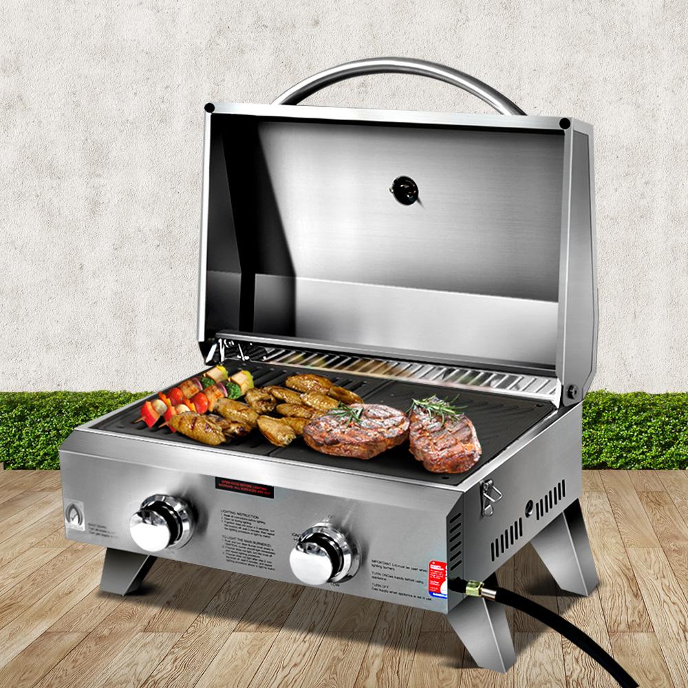 Grillz Portable Gas BBQ with two burners, stainless steel construction, and foldable legs, ideal for camping and outdoor cooking.