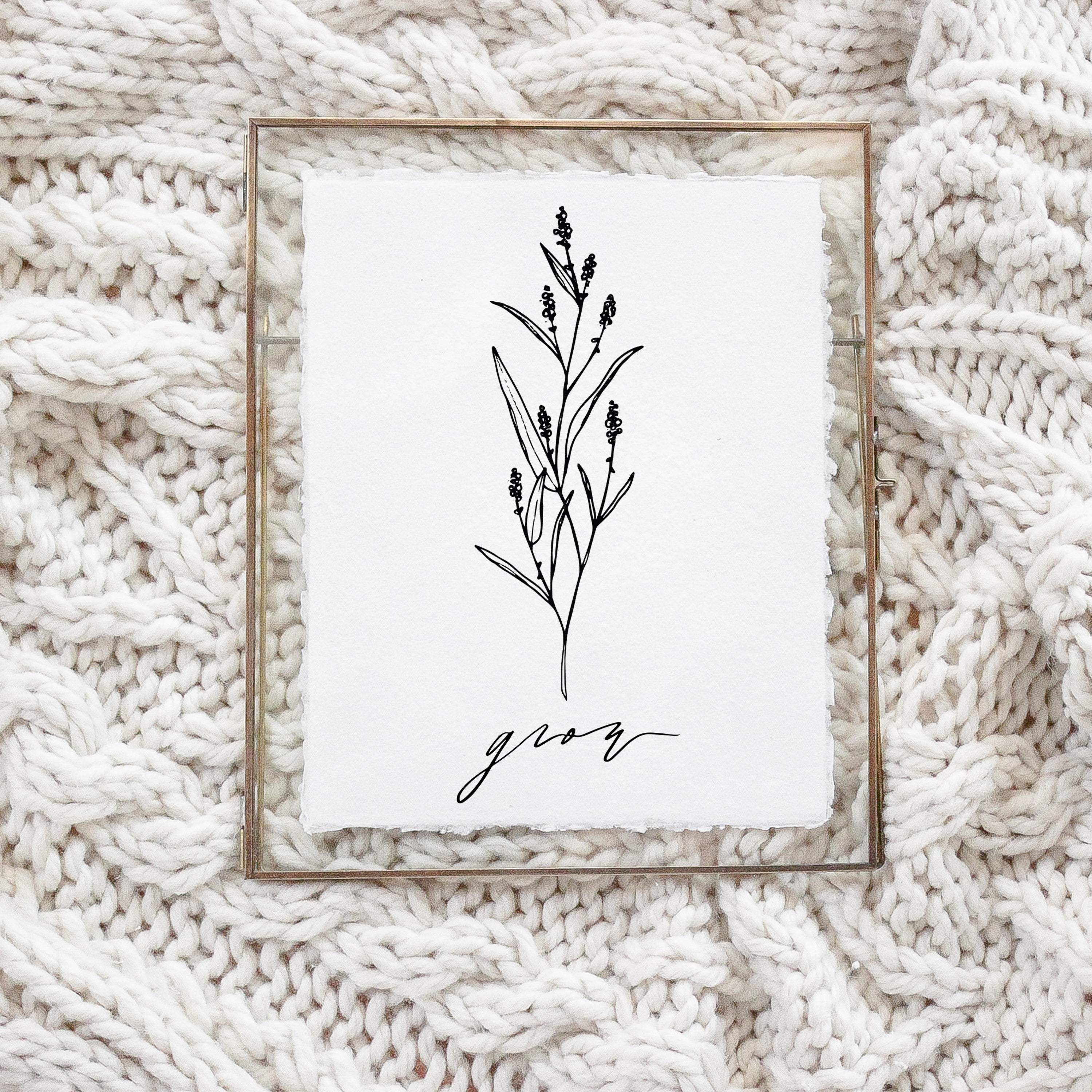 A beautifully designed Grow Wildflower Print featuring unique calligraphy and floral elements, displayed in a gold metal frame.