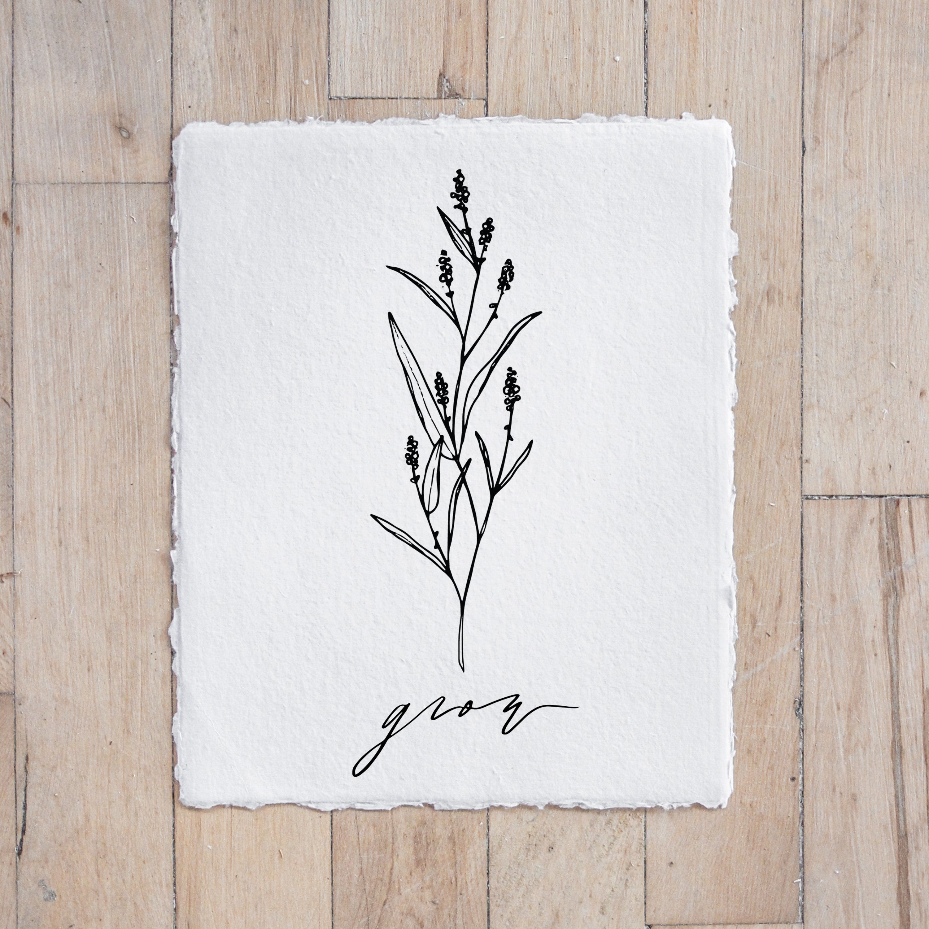 A beautifully designed Grow Wildflower Print featuring unique calligraphy and floral elements, displayed in a gold metal frame.