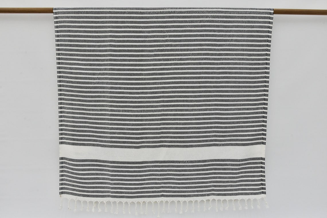 A beautifully designed Hammam towel made from 100% Turkish cotton, featuring a classic herringbone pattern, perfect for beach, yoga, and home use.