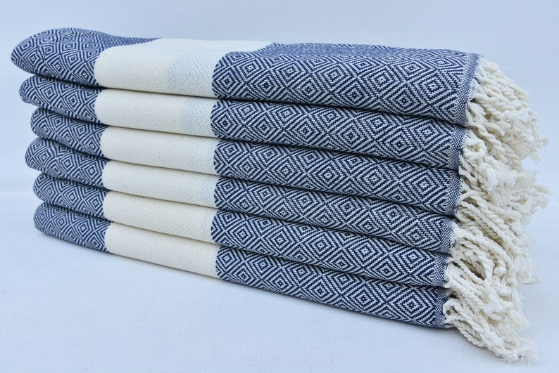 A beautifully designed Hammam towel made from 100% Turkish cotton, featuring a classic herringbone pattern, perfect for beach, yoga, and home use.