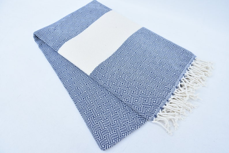 A beautifully designed Hammam towel made from 100% Turkish cotton, featuring a classic herringbone pattern, perfect for beach, yoga, and home use.