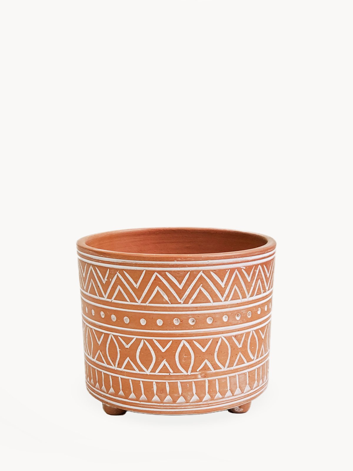 A small hand etched terracotta pot featuring dynamic geometric patterns, crafted from natural clay, ideal for indoor and outdoor use.