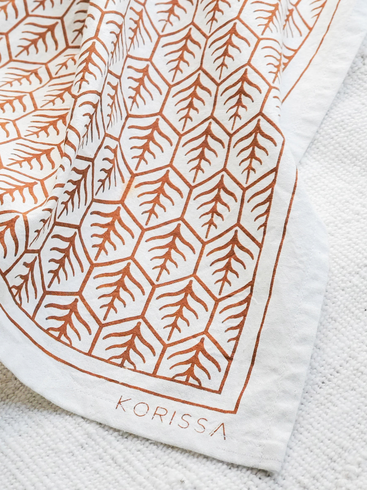 Set of 2 hand screen printed tea towels in natural cotton with artisan designs in light and dark brown.