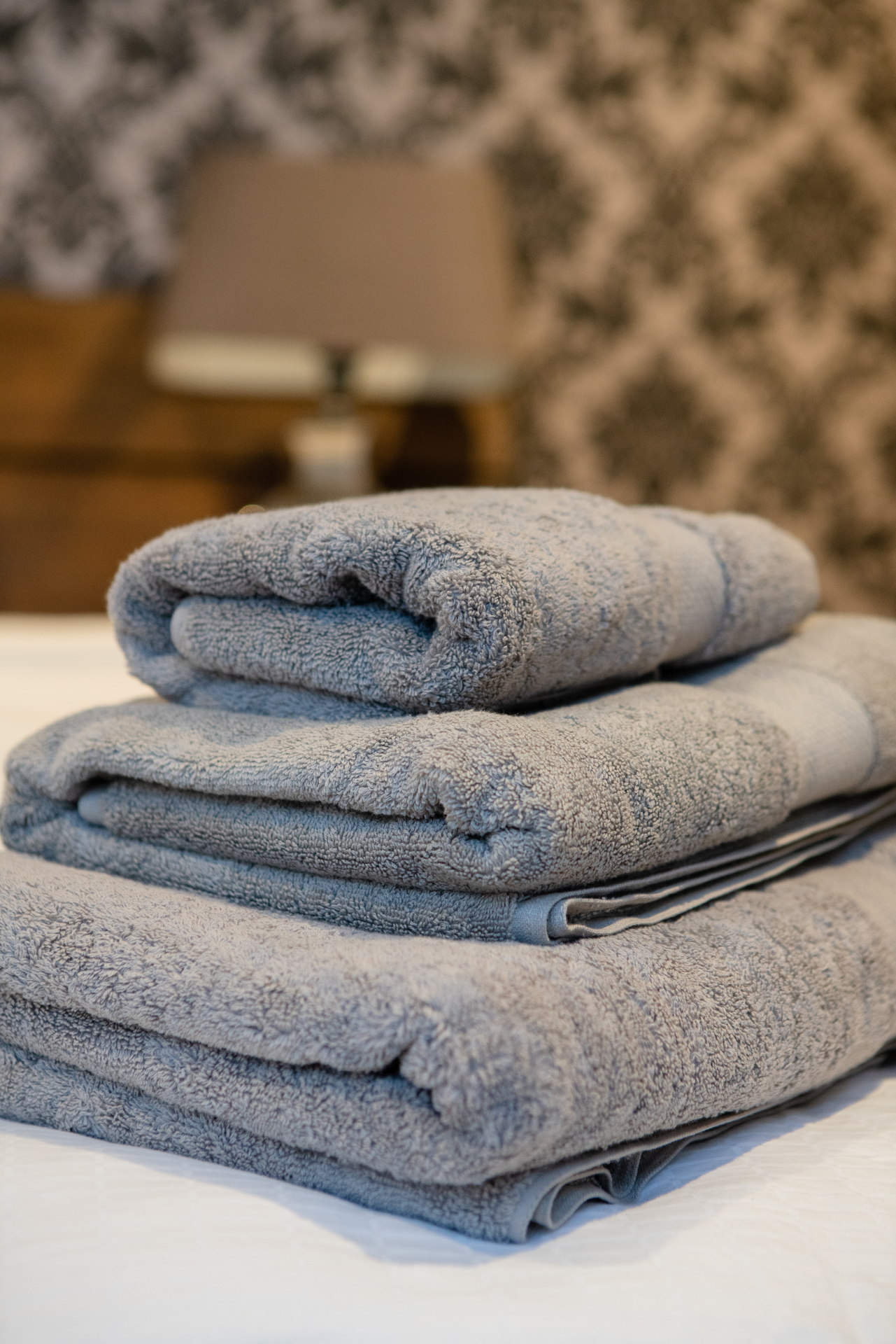 Luxurious grey hand towel made from 700gsm organic cotton, showcasing its plush texture and eco-friendly design.