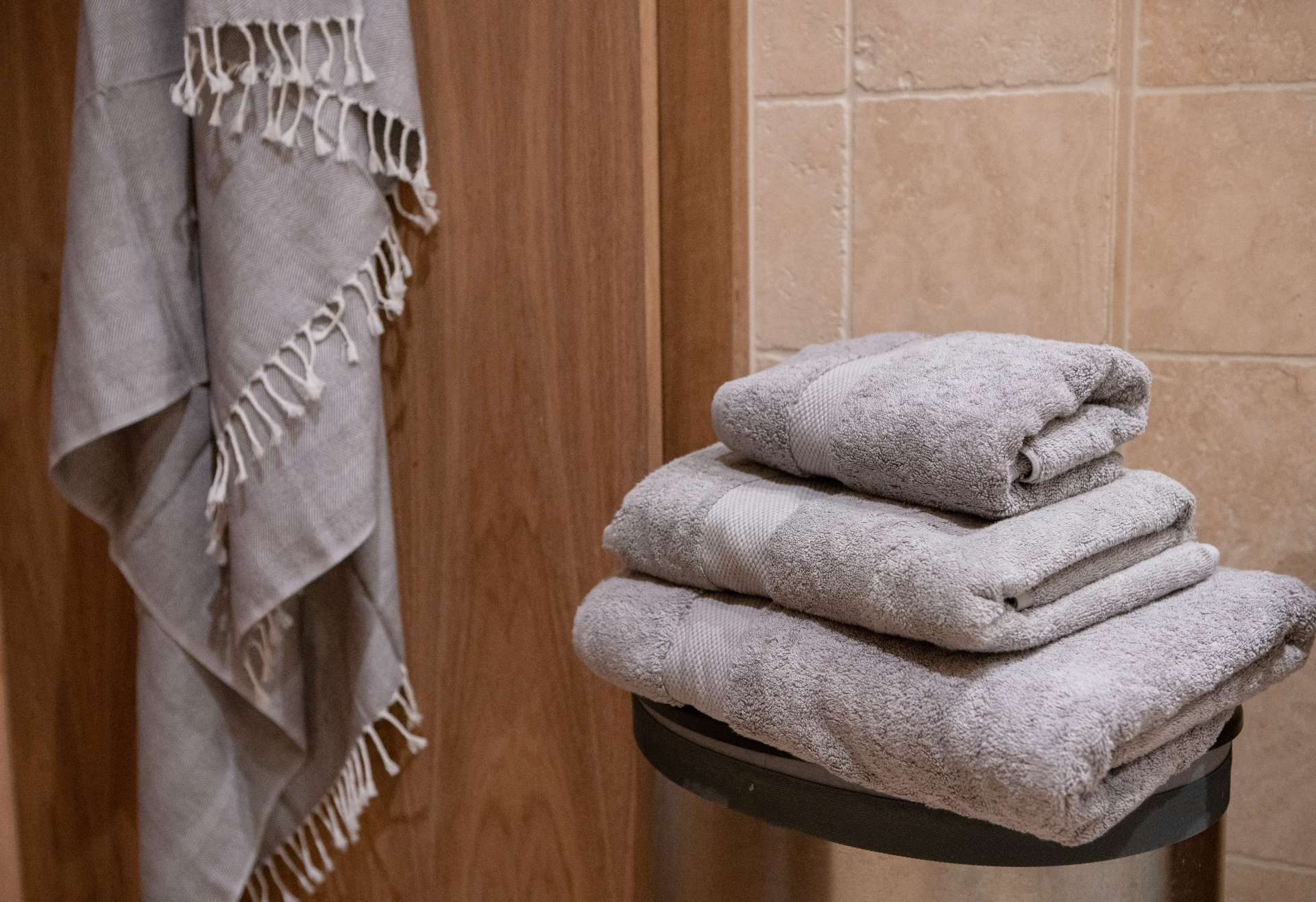 Luxurious grey hand towel made from 700gsm organic cotton, showcasing its plush texture and eco-friendly design.