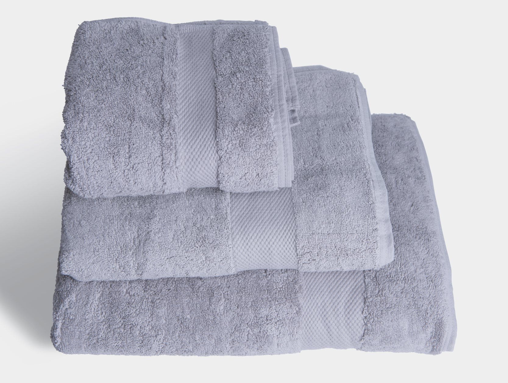 Luxurious grey hand towel made from 700gsm organic cotton, showcasing its plush texture and eco-friendly design.