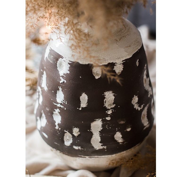 Handcrafted ceramic pottery vase in brown with a textured finish, showcasing unique shapes and colors.