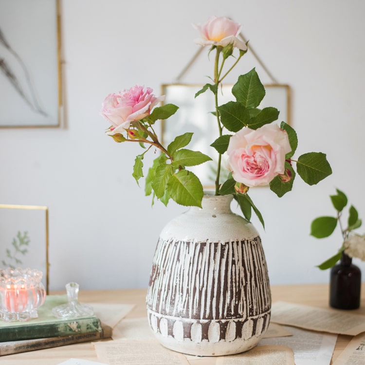 Handcrafted ceramic pottery vase in brown with a textured finish, showcasing unique shapes and colors.