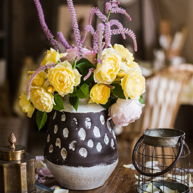 Handcrafted ceramic pottery vase in brown with a textured finish, showcasing unique shapes and colors.