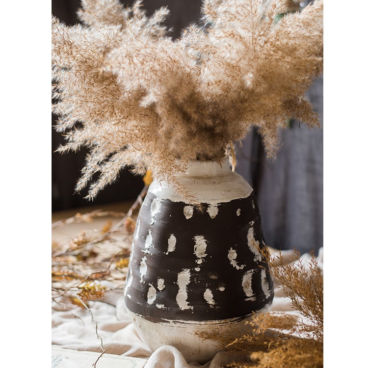 Handcrafted ceramic pottery vase in brown with a textured finish, showcasing unique shapes and colors.