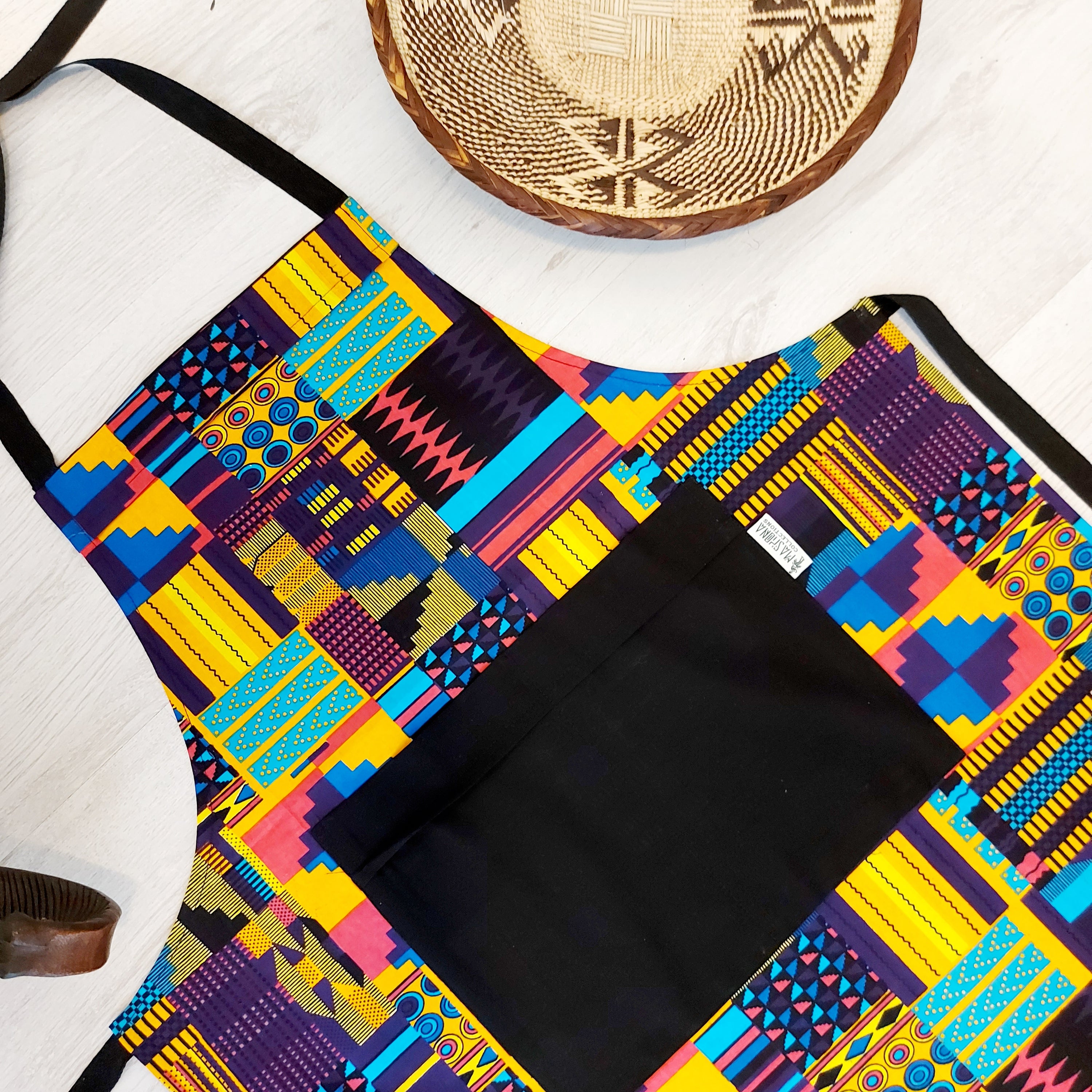 Handmade African Print Apron featuring vibrant Bogolan patterns, crafted from 100% cotton fabric with a convenient pocket.