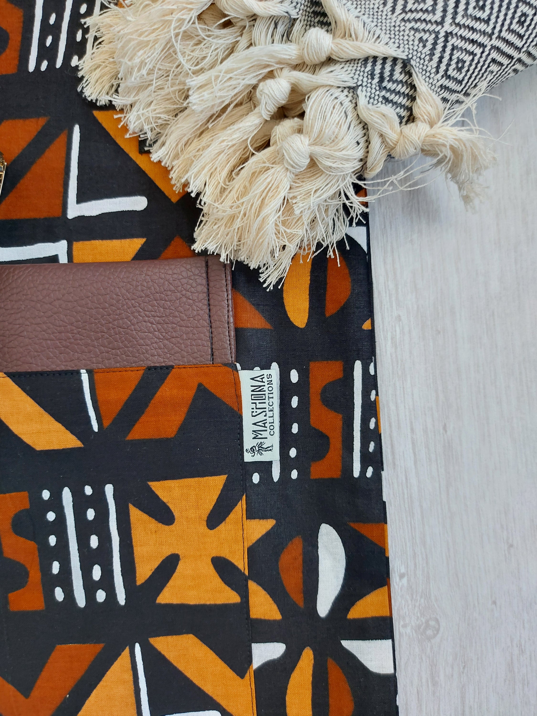 Handmade African Print Tote Bag featuring vibrant patterns, long handles, and eco-friendly cotton fabric, perfect for shopping and beach outings.