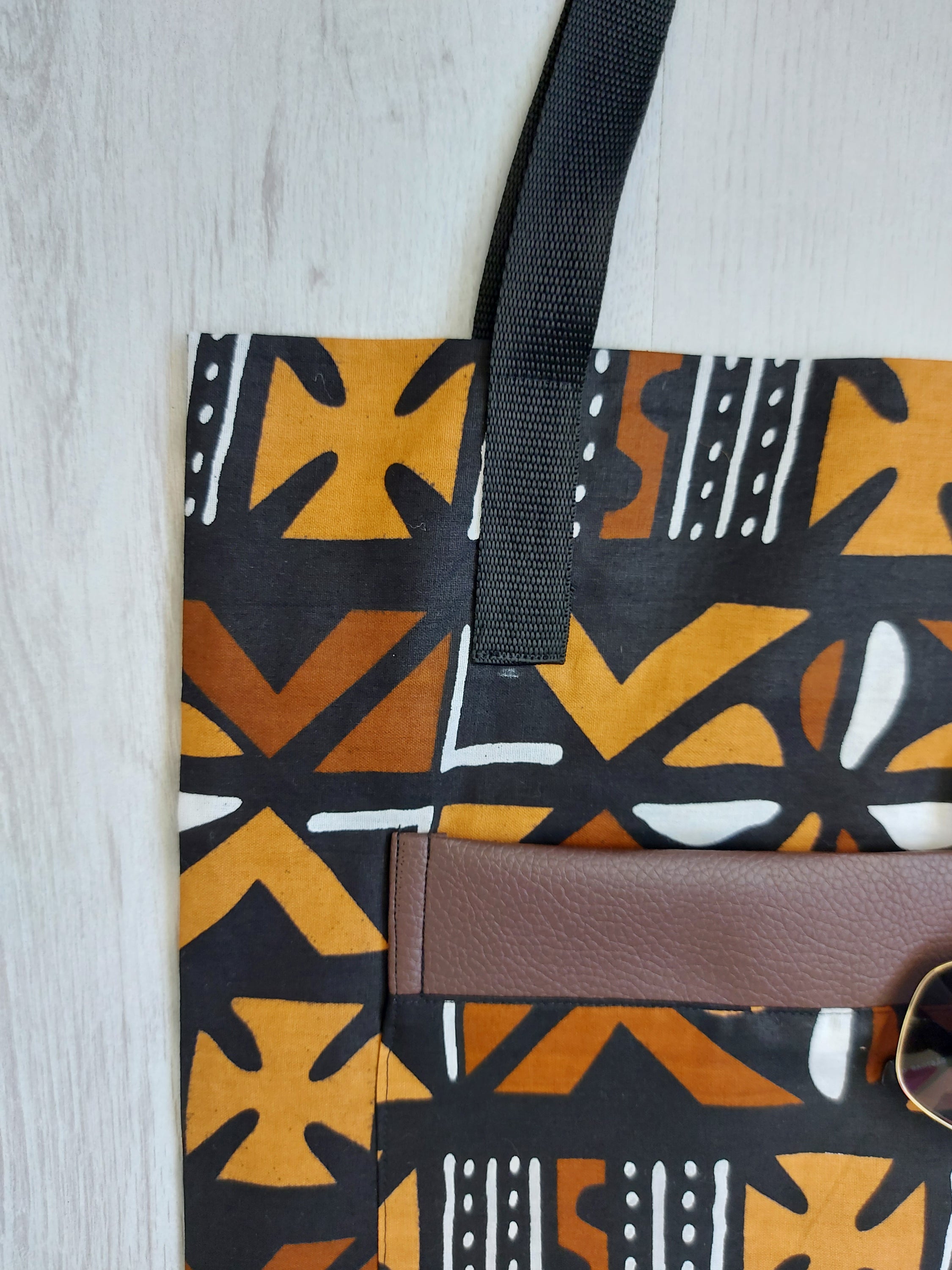 Handmade African Print Tote Bag featuring vibrant patterns, long handles, and eco-friendly cotton fabric, perfect for shopping and beach outings.