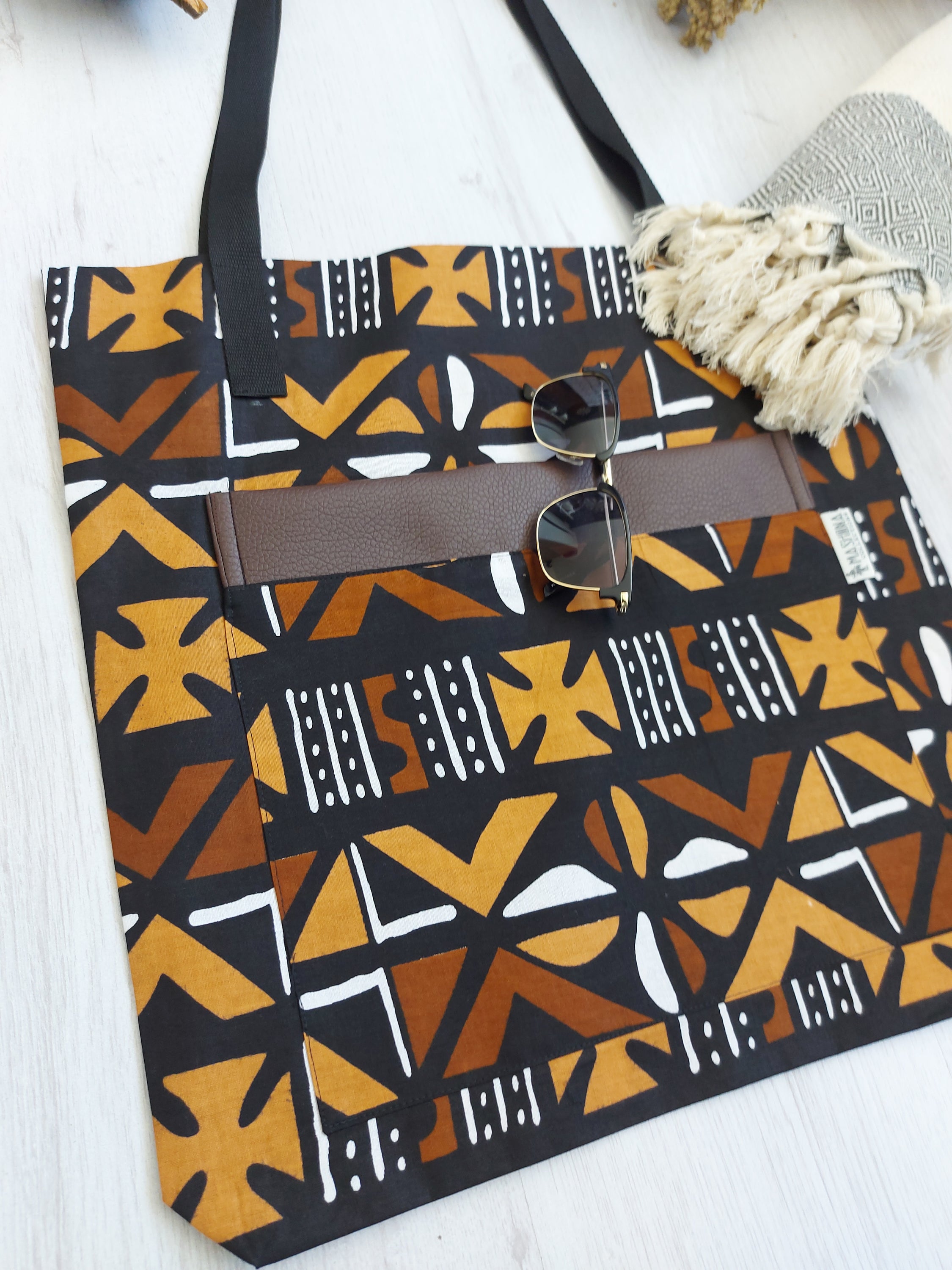 Handmade African Print Tote Bag featuring vibrant patterns, long handles, and eco-friendly cotton fabric, perfect for shopping and beach outings.