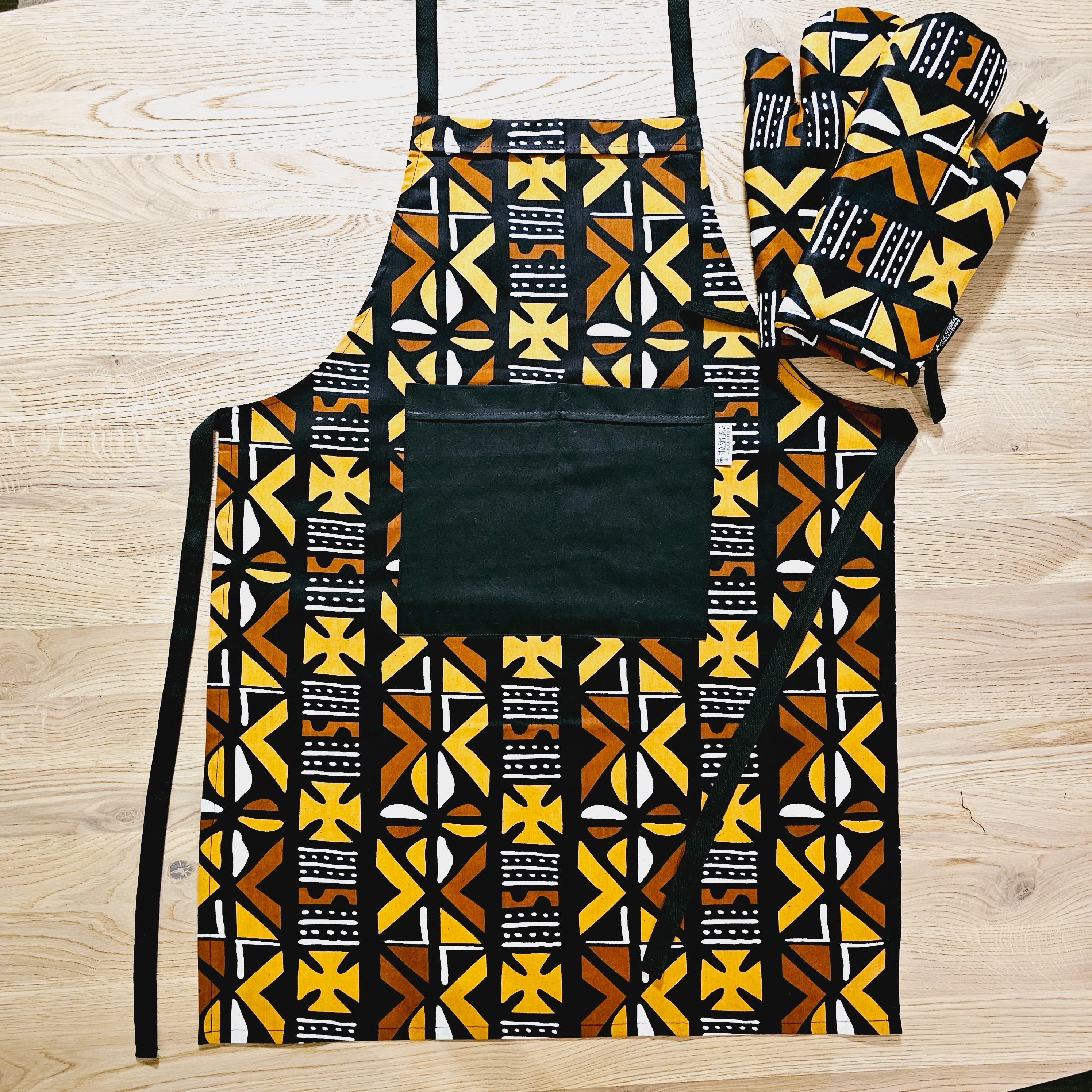 Handmade African Print Apron with matching oven gloves, showcasing vibrant colors and deep pockets, crafted from durable 100% cotton fabric.