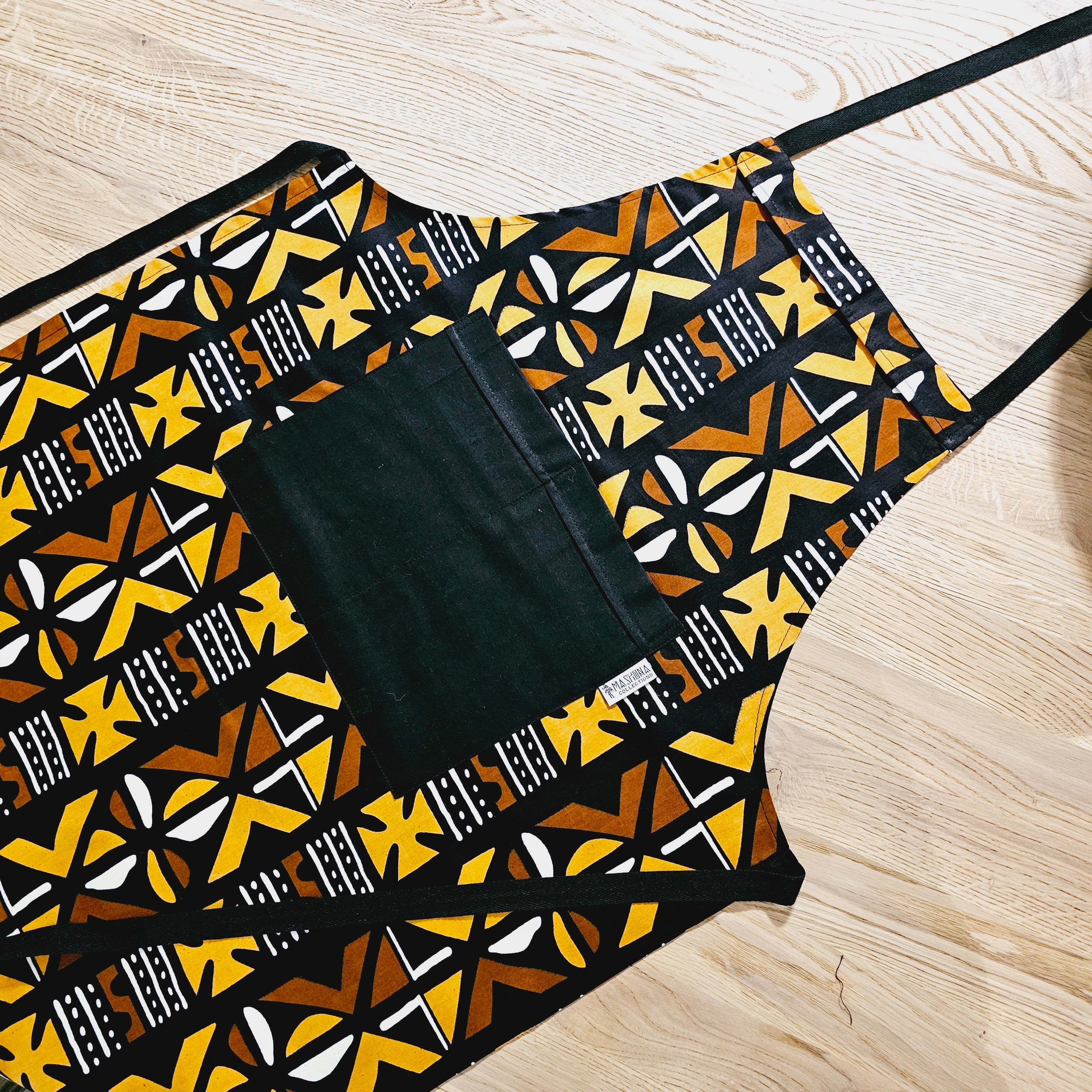 Handmade African Print Apron with matching oven gloves, showcasing vibrant colors and deep pockets, crafted from durable 100% cotton fabric.