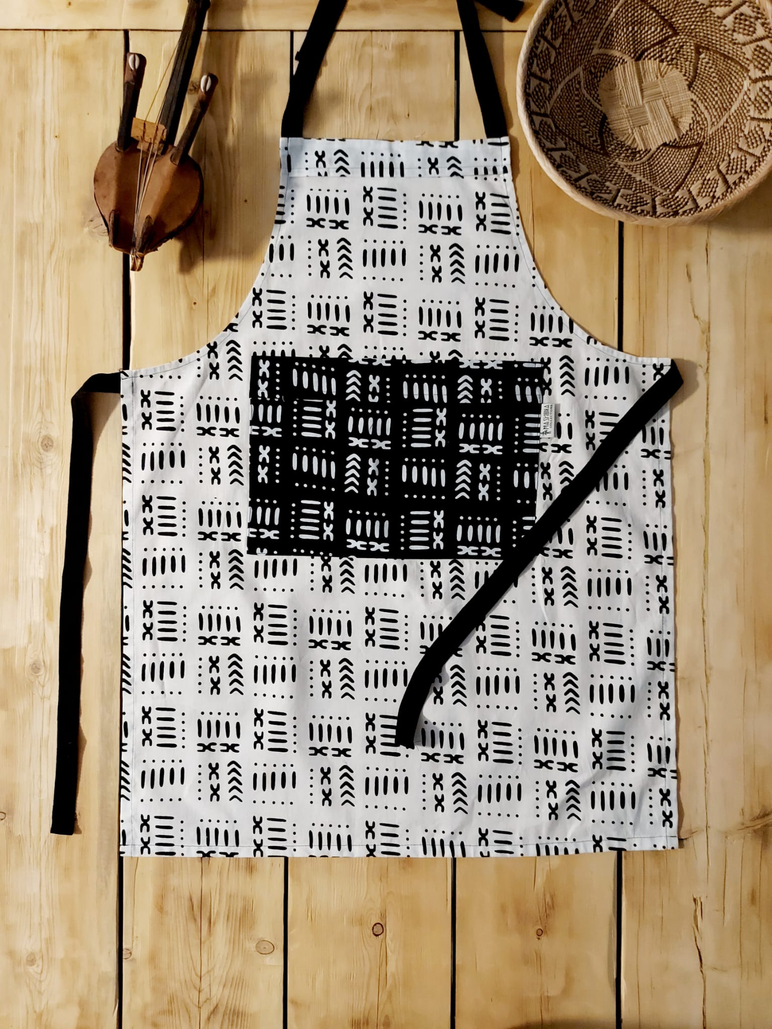 Handmade apron and matching oven gloves set featuring vibrant African print designs, showcasing quality cotton fabric.