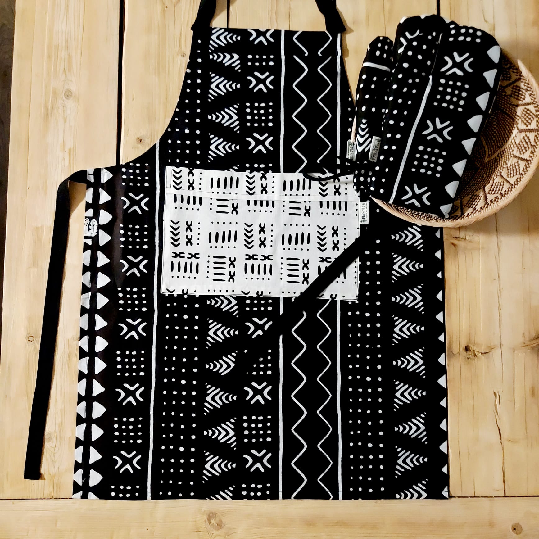 Handmade apron and matching oven gloves set featuring vibrant African print designs, showcasing quality cotton fabric.