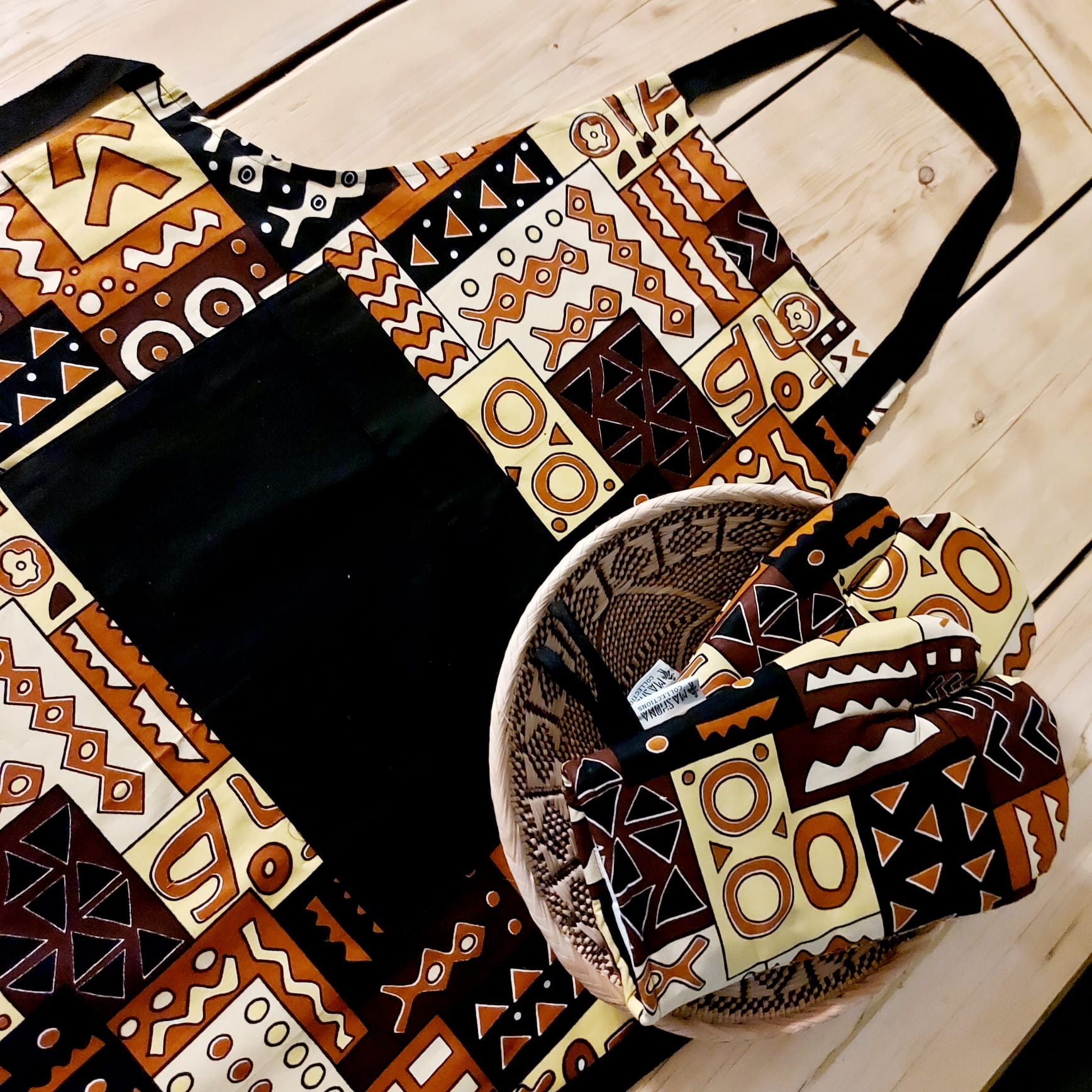 Handmade apron and matching oven gloves set featuring vibrant African print designs, showcasing quality cotton fabric.